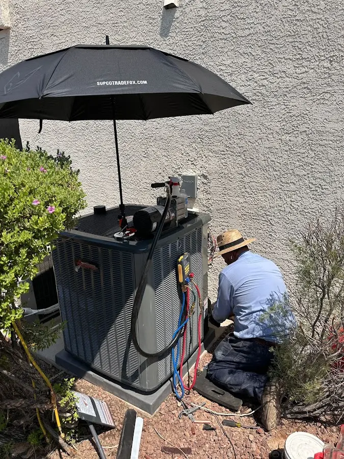 HVAC technician performing outdoor AC maintenance in Santa Fe