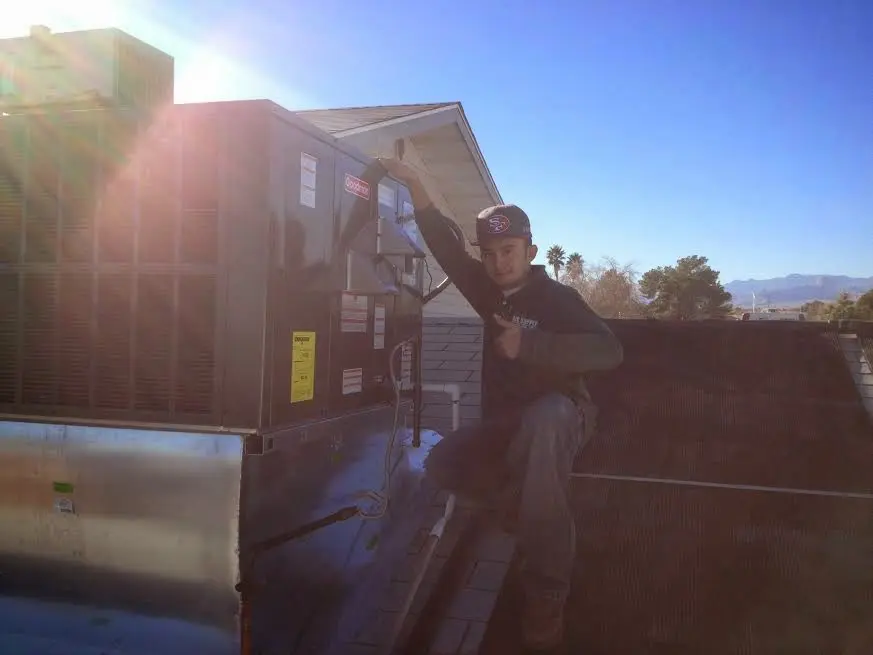 HVAC technician performing Heat Pump Repair on a rooftop unit in Santa Fe